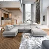 A spacious, modern living room with a large sectional sofa, dining area, and kitchen. Produktbild-Vorschau