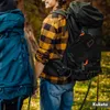 Two people with large backpacks are hiking in a forest. Náhled obrázku produktu