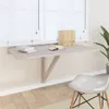 A fold-down desk mounted on a wall in front of a window, with a chair nearby. Náhled obrázku produktu