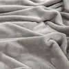 A close-up, textured view of a soft, gray blanket. Produktbild-Vorschau