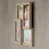 A collage of four picture frames mounted on a textured gray wall. Produktbild-Vorschau