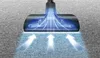 A vacuum cleaner head is shown hovering over a carpet, with blue arrows indicating airflow and suction. Produktbild-Vorschau