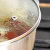 Close-up of a pot lid with condensation on it, sitting on a stovetop. Produktbild-Vorschau