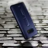 A dark blue Samsung phone case with a kickstand is shown on a textured stone surface. Produktbild-Vorschau