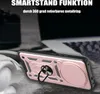 A rose gold phone case with a ring holder is shown on a textured surface, with a blurred laptop in the background. Produktbild-Vorschau