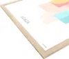 A close-up, angled view of a poster frame with a light wood finish. Produktbild-Vorschau