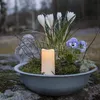 A decorative bowl with flowers, moss, and a candle. Anteprima dell’immagine prodotto