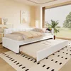 A white daybed with a pull-out trundle bed is shown in a bedroom setting. Náhled obrázku produktu