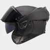 A black modular motorcycle helmet with the chin bar lifted. Voir les images du produit