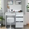 A white vanity table with a stool and decorative items, set against a light gray wall with artwork above. Podgląd zdjęcia produktu