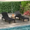 Two black sun loungers are set up on a patio next to a swimming pool, with an umbrella providing shade. Produktbild-Vorschau