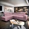 A pink sectional sofa in a modern living room with a spiral staircase and a fireplace. Podgląd zdjęcia produktu