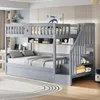 A grey bunk bed with stairs and storage shelves in a child's bedroom. Náhled obrázku produktu