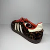 A single Adidas Samba OG shoe with a leopard print pattern is shown against a neutral background. Podgląd zdjęcia produktu