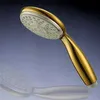 A gold-colored shower head is shown against a gradient blue and black background. Produktbild-Vorschau