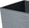 A close-up view of the top edge and textured exterior of a gray planter. Voir les images du produit