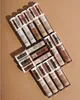 A collection of Catrice True Skin High Cover Concealers arranged diagonally on a light brown background. Voir les images du produit