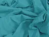 A close-up view of crumpled teal fabric. Produktbild-Vorschau