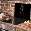 A kitchen counter with a stovetop, a cutting board with vegetables, and a glass splashback with an anime character. Produktbild-Vorschau