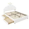 A white upholstered bed frame with a crown-shaped headboard and two pull-out drawers is shown against a white background. Anteprima dell’immagine prodotto