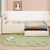 A child's bed with bedding and a rug on the floor. Produktbild-Vorschau