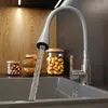 A kitchen scene with a faucet running water into a sink, surrounded by jars of food and wooden bowls. Podgląd zdjęcia produktu