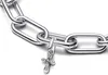 A close-up shot of a silver bracelet with a cross-shaped charm. Produktbild-Vorschau
