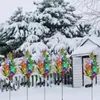 Decorative solar-powered cypress trees with LED lights in a snowy garden setting. Anteprima dell’immagine prodotto
