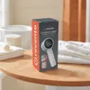A product box for a lint remover is placed on a wooden table next to folded towels and a bathtub. Náhled obrázku produktu