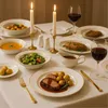 A formal dinner setting with a table laid with plates, cutlery, wine glasses, and candles. Náhľad obrázku produktu