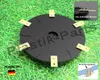 A black cutting disc with gold blades is displayed on a grassy surface. Produktbild-Vorschau