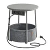 A round side table with a basket underneath. Produktbild-Vorschau