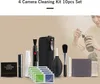 A collection of camera cleaning supplies is displayed on a light beige background, with a person in the background cleaning a camera lens. Voir les images du produit