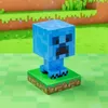 A blue Minecraft Creeper figure standing on a grassy base, with a pixelated background. Náhled obrázku produktu