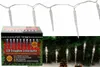 A collage showing a box of LED icicle lights and the lights themselves draped on a Christmas tree with pinecones. Produktbild-Vorschau