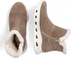 A top-down view of a pair of beige, fur-lined boots on a white background. Produktbild-Vorschau