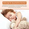 A young child sleeping soundly with a teddy bear. Produktbild-Vorschau