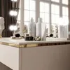 A vanity table with makeup and skincare products. Produktbild-Vorschau