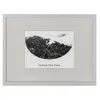 A framed black and white photograph of a misty forest scene with text below. Produktbild-Vorschau