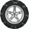 A close-up view of a car tire with snow chains installed. Produktbild-Vorschau