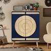 A blue cabinet with circular wooden doors is shown in a room setting, with plants and decorative items on top. Anteprima dell’immagine prodotto