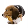 A beagle puppy chewing on a yellow dog toy. Náhled obrázku produktu