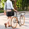 A person walks with a bicycle and a black cooler bag in a park. Produktbild-Vorschau