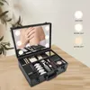 A makeup case with a lighted mirror and various makeup products inside, displayed on a wooden table. Produktbild-Vorschau