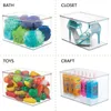 A collage of four clear plastic storage bins, each filled with different items and labeled. Produktbild-Vorschau