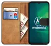 A book-style phone case with a phone inside, showing cards and banknotes in the wallet section. Produktbild-Vorschau