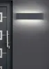 A modern dark gray door with a silver handle and a rectangular wall light mounted on a gray wall. Produktbild-Vorschau