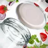 A glass jar and lid are shown with various salad ingredients floating around them. Podgląd zdjęcia produktu