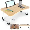 A laptop table with a tablet, phone, cup, and pens on it, shown from a slightly elevated angle. The table is set against a white background, with additional views of the table folded and unfolded shown below. Produktbild-Vorschau
