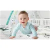 A baby is playing on a colorful play mat with hanging toys. Anteprima dell’immagine prodotto